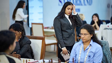 Divya Deshmukh steals a glance at Koneru Humpy's game during the women's game against Mongolia on Saturday. Deshmukh won her match 