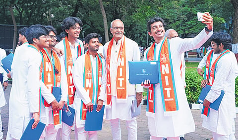 Students taking selfie with their professor.