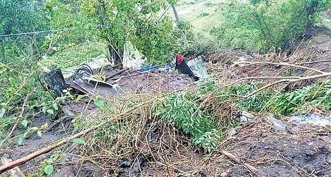 The farm shed buried under debris after a landslide at Kottakamboor in Idukki district on Sunday.