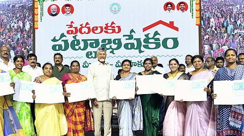 Chief Minister Nara Chandrababu Naidu with the beneficiaries of house site title deeds in Visakhapatnam on Saturday.