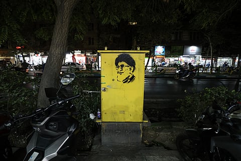 A photograph shows graffiti depicting late Iranian leader Ali Khamenei on a shopping street in southern Tehran on September 15, 2026.