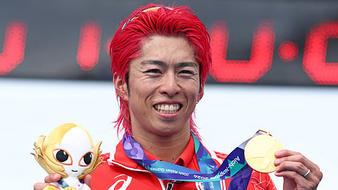 Japan's Takumi Hojo holds his gold medal on the podium of the men's individual triathlon during the 2026 Asian Games in Gamagori city near Nagoya, Aichi Prefecture, on September 20, 2026. 