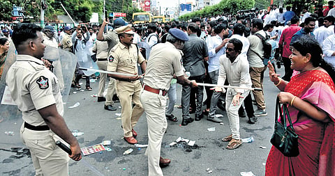 Police cane YSRCP activists as they blocked the road near SAAP office in Vijayawada,  demanding probe into alleged irregularities in DSC recruitment  