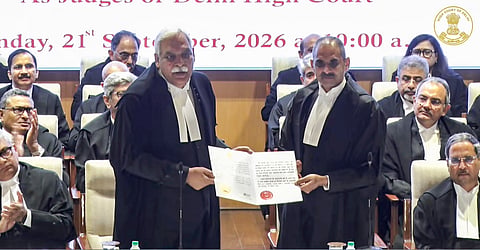 Delhi High Court Chief Justice Devendra Kumar Upadhyaya, left, after administering the oath of office to Justice Dinesh Bhatt as a Delhi High Court judge, in New Delhi.