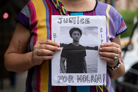 A person holds a picture of Nolan Xavier Wells during a news conference at National Action Network headquarters, Friday, July 10, 2026, in New York.