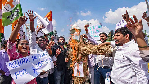 Bihar Youth Congress activists burn an effigy as they stage a protest against the Bihar government following the viral video showing a boy and a girl allegedly being harassed by a group of people on a roadside in Jamui district, in Patna, Tuesday, Sept. 22, 2026.