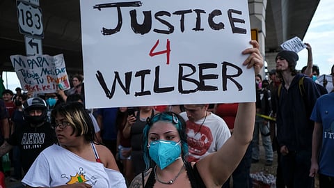 People speak during a demonstration where a man was shot in his vehicle by an ICE officer, Sunday, Sept. 20, 2026, in Austin, Texas. 