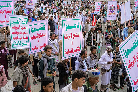 Supporters of the Houthi authorities march as they hold placards reading "Boycott American and Israeli goods" during a protest against the Saudi intervention in Yemen and against Saudi Arabia's recent accusation that the Houthis fired at the holy city of Mecca, in Yemen's western Red Sea city of Hodeida on September 18, 2026.