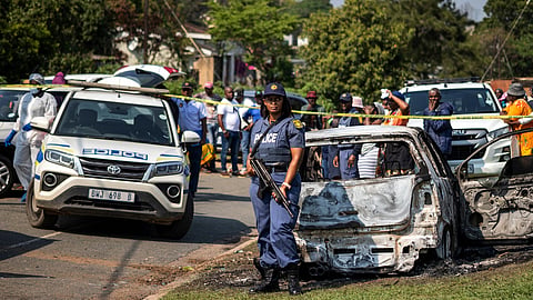 A police officer stands at the scene of a mass shooting at a house party in KwaMakhutha township south of the city of Durban, South Africa, Wednesday, Sept. 23, 2026.