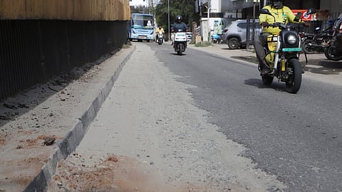 Motorists pass through a damaged stretch of Tiruchy Road in Coimbatore on Tuesday. 
