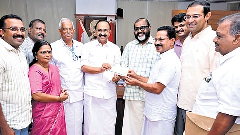 Jose K T, owner of He-Man Robo Park at Angamaly, handing over a cheque worth 
Rs 40 lakh to Chief Minister V D Satheesan to buy a bus