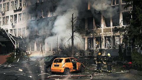 Ukrainian rescuers work to extinguish a fire in an office building following an air attack in Kyiv on September 23, 2026, amid the Russian invasion of Ukraine.
