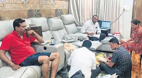 NIMS additional superintendent Nori Lakshmi Bhaskar, extreme left, watches ACB officials search his residence in Hyderabad on Tuesday.