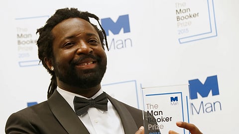  Jamaican author Marlon James poses with the award after his book, "A Brief History of Seven Killings," was named as winner of the 2015 Booker Prize for Fiction in London on Oct. 13, 2015.