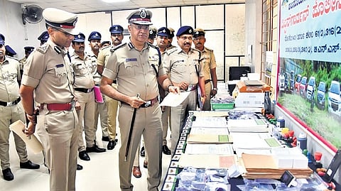 City Police Commissioner Seemanth Kumar Singh inspects the duplicate stamp papers seized by Wilson Garden police in Bengaluru on Wednesday.
