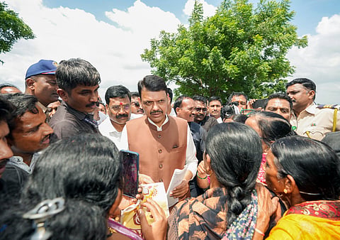 Maharashtra Chief Minister Devendra Fadnavis interacts with people while inspecting the areas affected by the drought-like situation at Mohagavhan, Mangrulpir taluka, in Washim on Thursday.