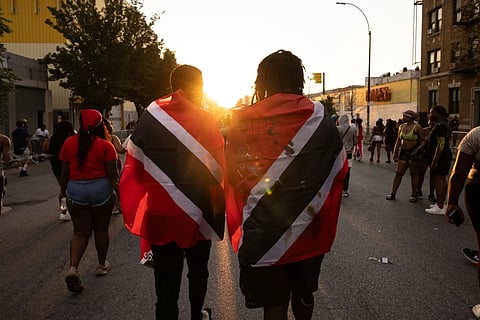 People with Trinidad and Tobago flag are seen during J'ouvert celebration, Sept. 4, 2023, in the Brooklyn borough of New York. 