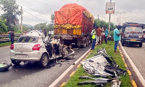 People gather at the site after a car rammed into a stationary truck, in Jamshedpur, Thursday, Sept. 24, 2026. Jharkhand minister Dipika Pandey Singh's daughter was among four people killed in the incident. 