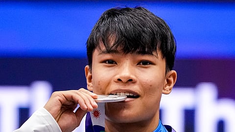 India' s Roshibina Devi Naorem holds the silver medal after the Women' s 60kg Wushu final match during the 20th Asian Games, in Nagoya, Japan, Thursday, Sept. 24, 2026.