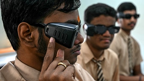 Visually-impaired students using AI-powered smart glasses designed for face recognition, object recognition and navigation assistance during a training programme at a school in Hyderabad