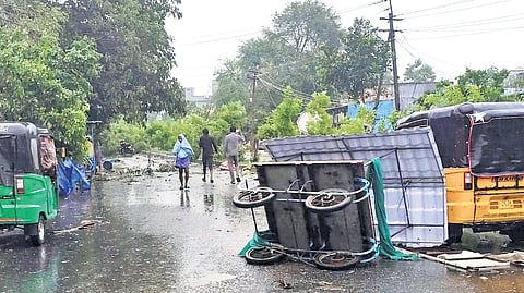 The aftermath of tornado-like winds that swept through Morampalli Banjara village, leaving a cart overturned and debris scattered across the road.