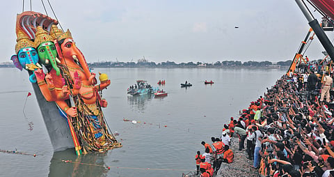 Devotees watch the 69-foot Khairatabad ‘Bada Ganesh’ being immersed in Hussainsagar 