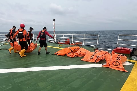 In this photo released by Indonesia's National Search and Rescue Agency (BASARNAS), rescuers carry the body of a victim of a ferry capsize in rough seas earlier this month, aboard a search-and-rescue vessel in the Java Sea, Indonesia, Friday, Sept. 25, 2026.