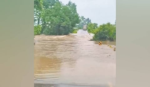 Rainwater flowing over NH-326 at MV-96 in Malkangiri on Thursday.