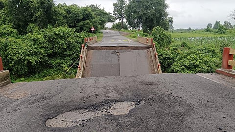 A portion of a bridge at Rajupeta in Mulakalapalli mandal of Bhadradri Kothagudem district is washed away by overflowing floodwaters following torrential rains, disrupting traffic in the area.