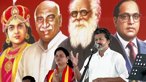 Tamil Nadu Chief Minister and TVK President C Joseph Vijay speaks as party candidate K. Maragatham Kumaravel, left, looks on during a campaign rally for the Madurantakam Assembly constituency by-election, in Chengalpattu district. 