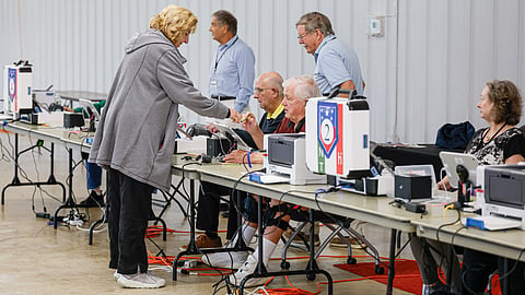 A woman checks in before voting on the second day of early voting ahead of the midterm elections, at a polling place at DuPage Event Center and Fairgrounds in Wheaton, Illinois, on September 25, 2026.