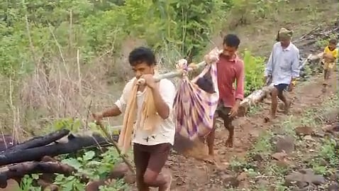 Tribal people on the hills carrying patients in doli in remote villages in Polavaram district. 