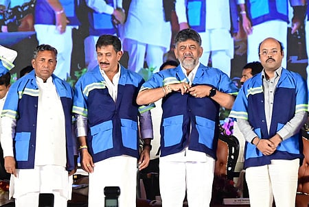 Chief Minister DK Shivakumar with ministers Balakrishna, KH Muniyappa, Yatindra Siddaramaiah and others during Pourakarmika Day 2026 at Palace Grounds in Bengaluru on Friday.