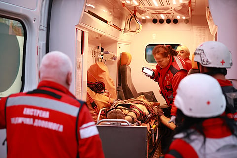 Medics inspect a body of a woman killed in a Russian strike on residential neighbourhood on Zaporizhzhia, Ukraine, on Saturday, Sept. 26, 2026. 