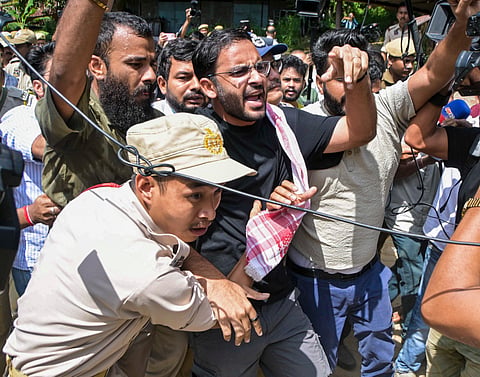 Police personnel detain Cockroach Janta Party (CJP) co-convenor Ashutosh Ranka and other party activists as they raise slogans ahead of their scheduled first regional volunteers' meeting near the Assam Secretariat, in Guwahati, Assam, Sunday, Sept. 27, 2026. 