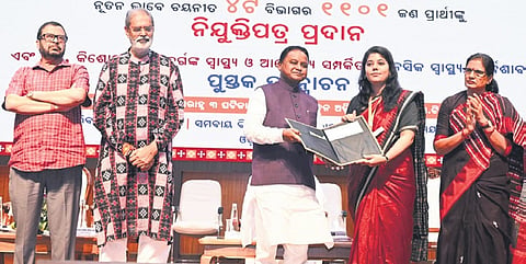 Chief Minister Mohan Charan Majhi handing over an appointment letter to one of the new recruits at OUAT Auditorium