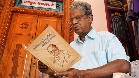  Book publisher Chandrasekharan poses with some of the books from his personal collection at his home library, which houses nearly 5,000 books, at Keezperum Pakkam in Villupuram district. 