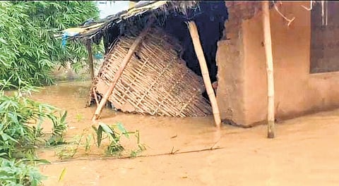 Floodwater entered a house in Kotpad block in Koraput district (L), an elderly couple walking on an inundated road in Bhadrak on the day (R).