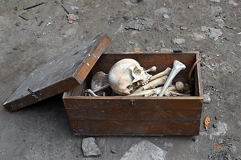 A skeleton-like object kept inside an old wooden chest discovered during a cleanliness drive in a scrap collection area, in New Delhi on Saturday.