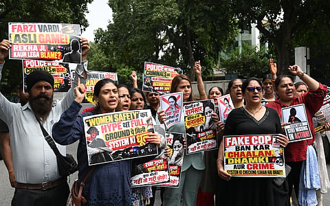 All India Mahila Congress members raise slogans and display placards during a protest march against rising crimes against women, in New Delhi on Saturday.