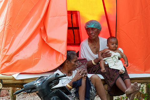 This picture taken on September 17, 2026 shows evacuees resting outside an evacuation centre at Cawalo hamlet, Rokirole village, Sikka regency, East Nusa Tenggara province, following a 7.7-magnitude earthquake on August 15.