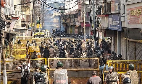 Security personnel keep vigil following stone-pelting incidents during protests against the proposed removal of a portion of the 'Shahi Masjid' for road widening, in Ujjain, Madhya Pradesh, Monday, Sept. 28, 2026.