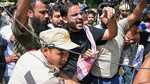 Police personnel detain Cockroach Janta Party (CJP) co-convenor Ashutosh Ranka and other party activists as they raise slogans ahead of their scheduled first regional volunteers' meeting near the Assam Secretariat, in Guwahati, Assam, Sunday, Sept. 27, 2026.