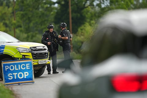 Police guard a road leading to RAF Fairford, a US Airbase, after an incident in Fairford, England , Sunday, Sept. 27, 2026.