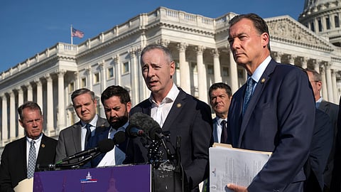 Rep. Brian Fitzpatrick, R-Pa., center, and Rep. Tom Suozzi, D-N.Y., right, talk to reporters about partisan gerrymandering, the reshaping of congressional districts to benefit one political party, during a news conference at the Capitol in Washington, Wednesday, Sept. 16, 2026.
