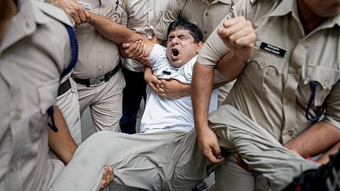 Police personnel detain Indian Youth Congress (IYC) National President Uday Bhanu Chib during a protest demanding the resignation of Chief Election Commissioner Gyanesh Kumar over electoral roll revisions, near the Election Commission of India (ECI) headquarters, in New Delhi, Monday, Sept. 28, 2026.