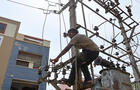 An EB worker working on a transformer in Tiruchy