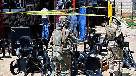 Forensic officers and the army members are seen at scene of a mass shooting on Saturday night when suspects opened fire at a bar in Wedela township, southwest of Johannesburg, South Africa, Sunday, Sept. 27, 2026.