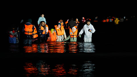 In this photo from Sept. 23, 2026, a group of migrants try to cross the channel from France to Britain on a dinghy boat, in Hardelot, northern France.
