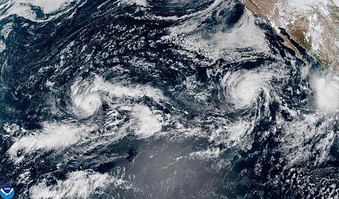 This satellite image provided by NOAA shows Tropical Storm Nolo, left, south of Hawaii; Hurricane Odalys, middle, and Hurricane Polo, right, off the coast of Mexico, in the Pacific Ocean on Thursday, Sept. 24, 2026. 